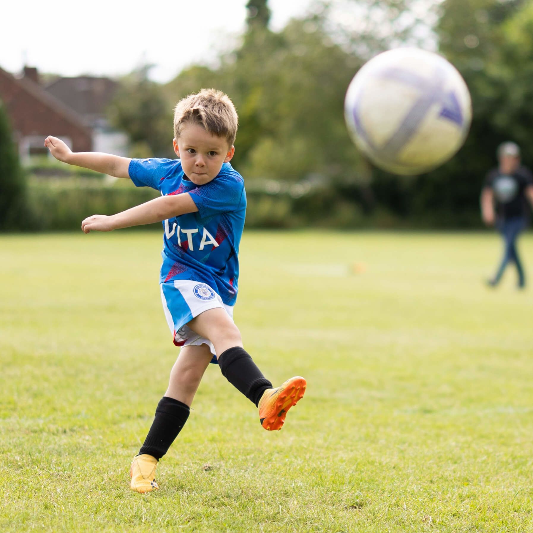 Child kicking football