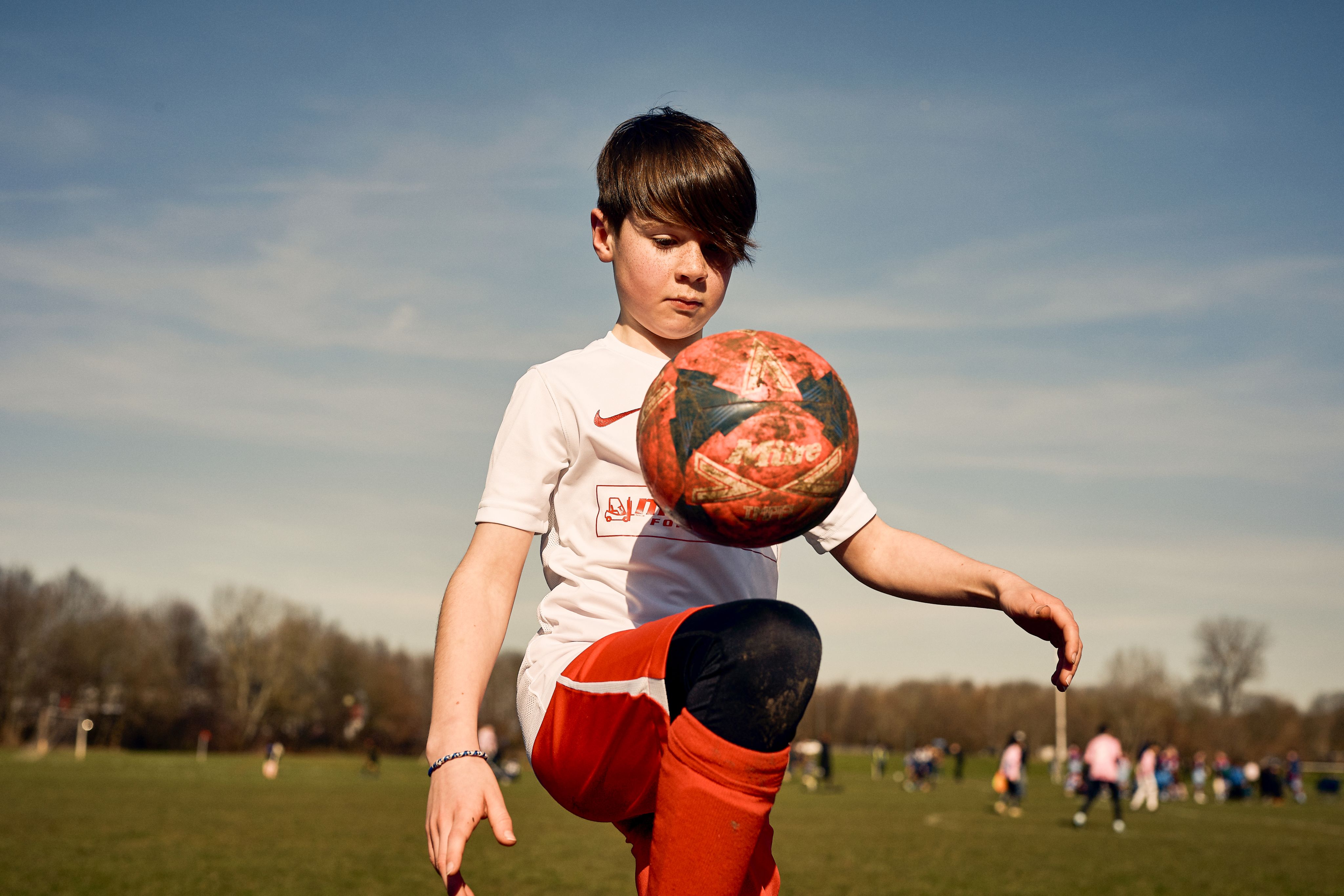 Child kicking football