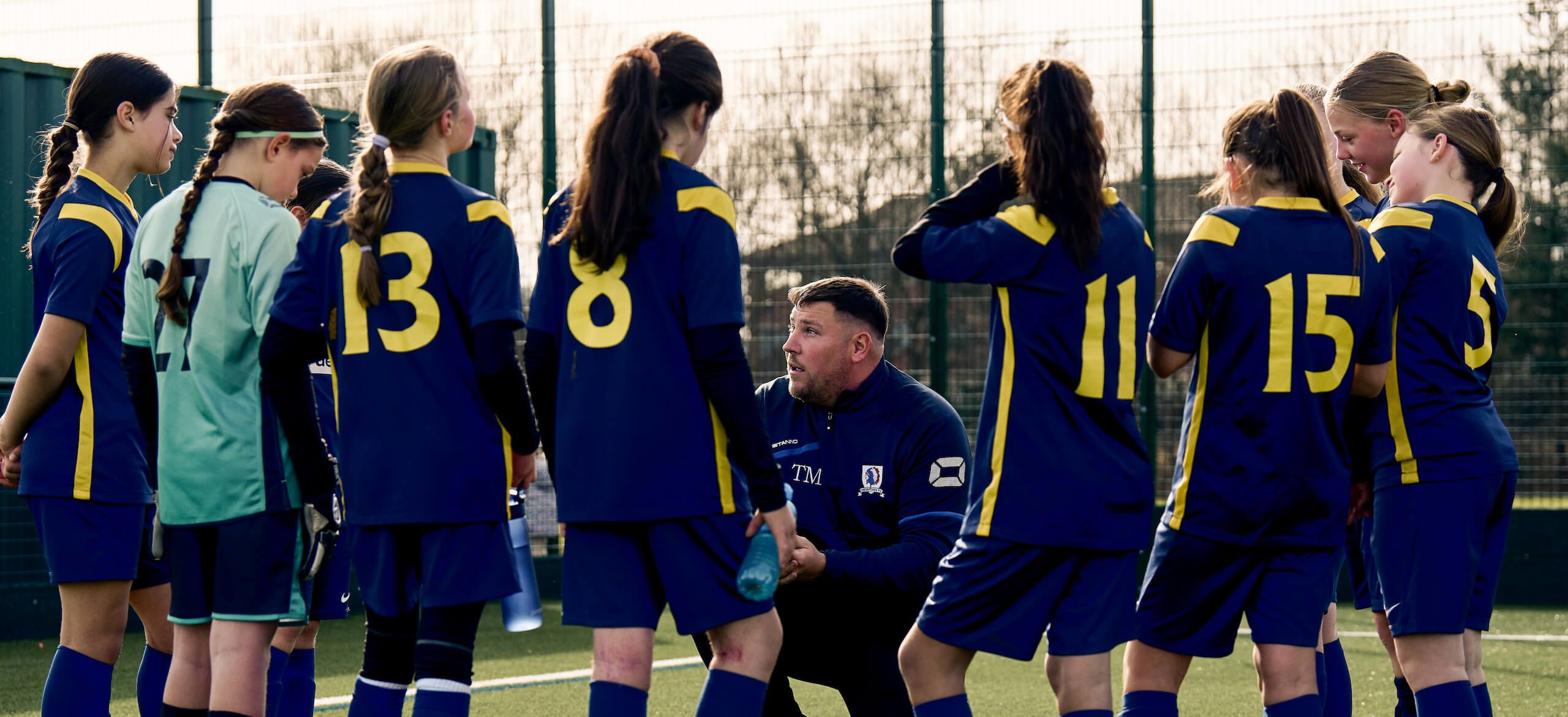 Coach talking to football players