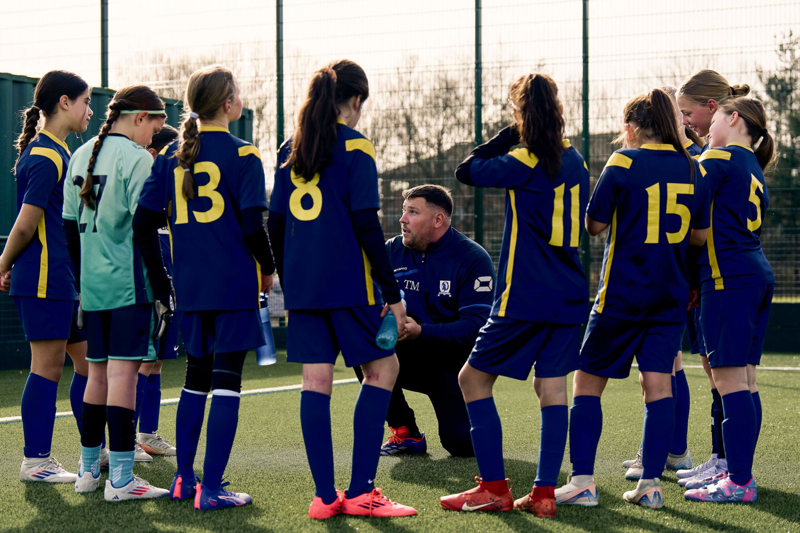 Coach talking to football players